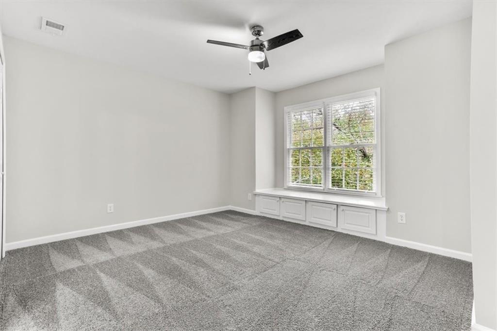 3425 Kingsland Circle Berkeley Lake, GA 30096 - Photo 31 of 45 an empty room with windows and ceiling fan