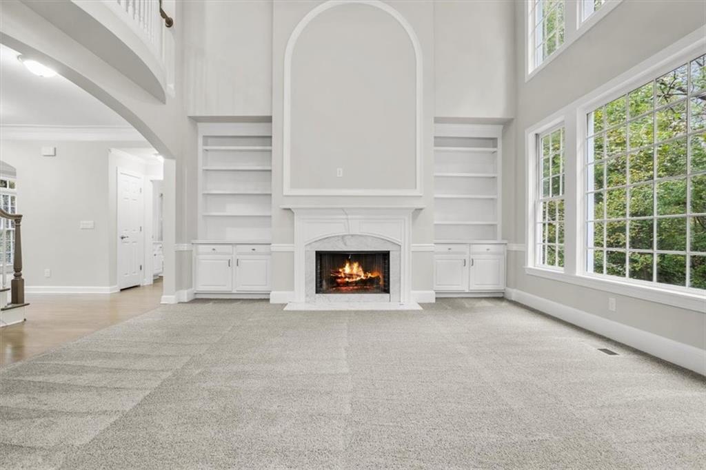 3425 Kingsland Circle Berkeley Lake, GA 30096 - Photo 6 of 45 a view of an empty room with a fireplace and a window