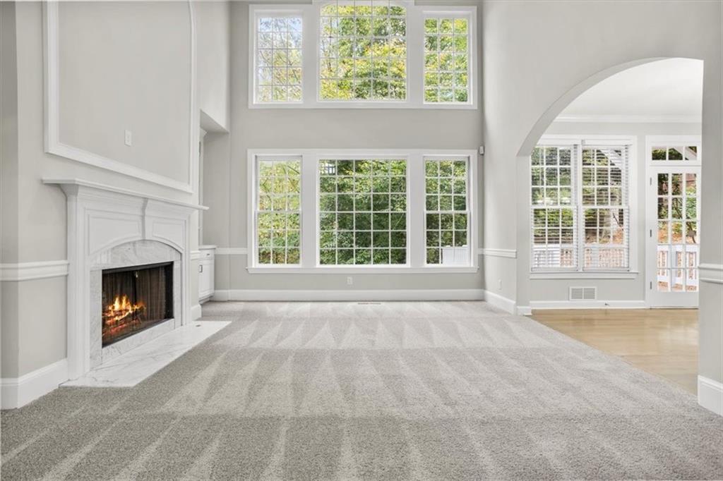 3425 Kingsland Circle Berkeley Lake, GA 30096 - Photo 7 of 45 a view of an empty room with a fireplace and a window