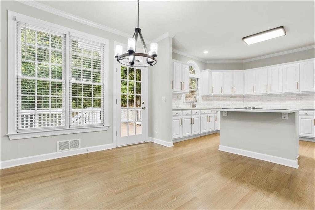 3425 Kingsland Circle Berkeley Lake, GA 30096 - Photo 10 of 45 a kitchen with stainless steel appliances granite countertop a stove a sink dishwasher a refrigerator and white cabinets with wooden floor