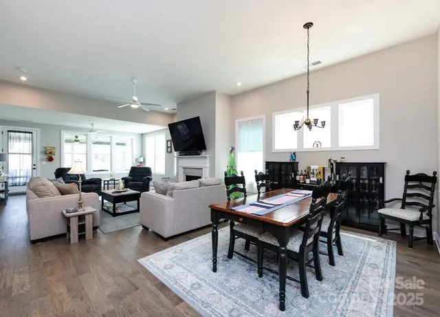 a living room with furniture a rug and a flat screen tv