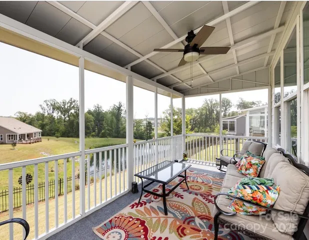 a view of a chairs and table in patio with a garden