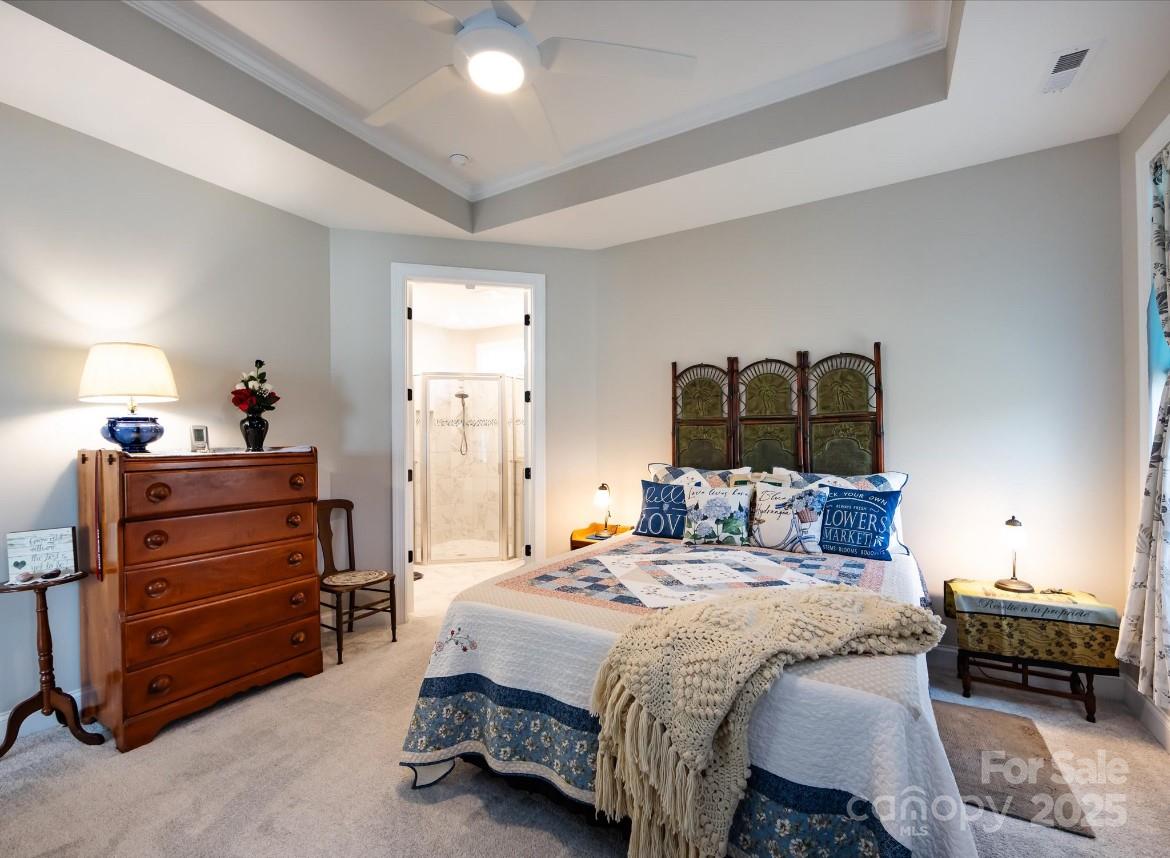 7337 Overjoyed Crossing Charlotte, NC 28215 - Photo 19 of 28 a bedroom with a bed and a mirror