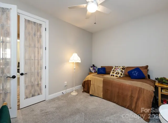 a living room with a bed and a chandelier