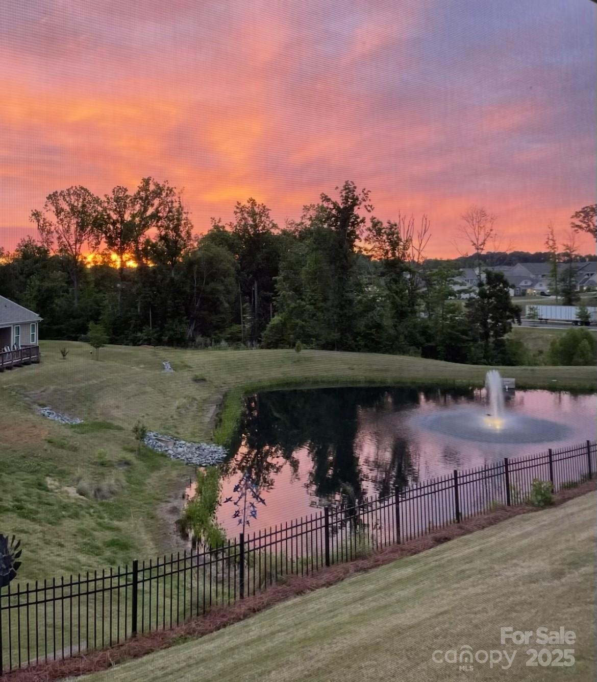 7337 Overjoyed Crossing Charlotte, NC 28215 - Photo 4 of 28 a view of a lake with a mountain in the background