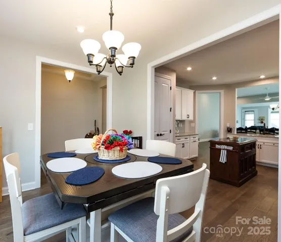 a view of a dining room with furniture and a chandelier