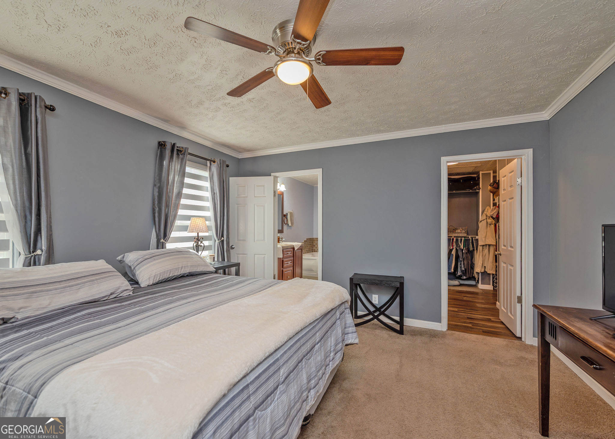272 Lakeside Trail Martin, GA 30557 - Photo 12 of 35 a bedroom with a bed and a chandelier