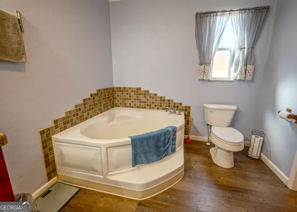 a bathroom with a sink toilet and window