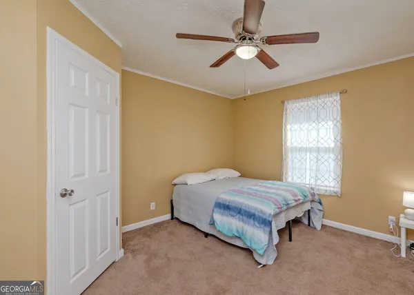 a bed sitting in a room next to a window