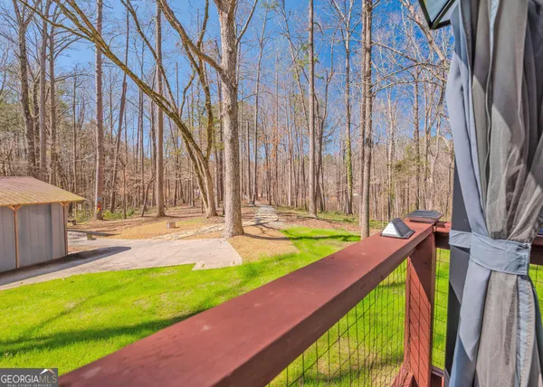 a view of a backyard with a small pool and wooden chair