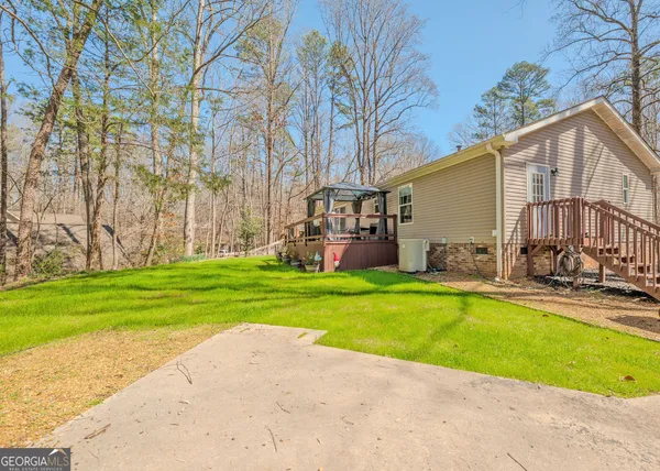 a view of a house with a yard and sitting area