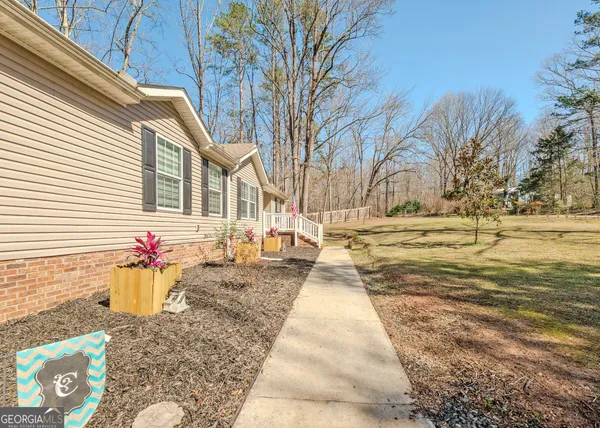 a backyard of a house with wooden fence and trees