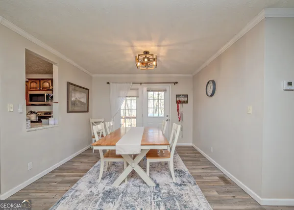 a dining room with wooden floor and a window