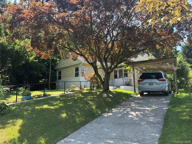 a house view with a sitting space and garden