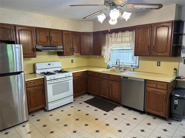 a kitchen with a cabinets a sink and a stove