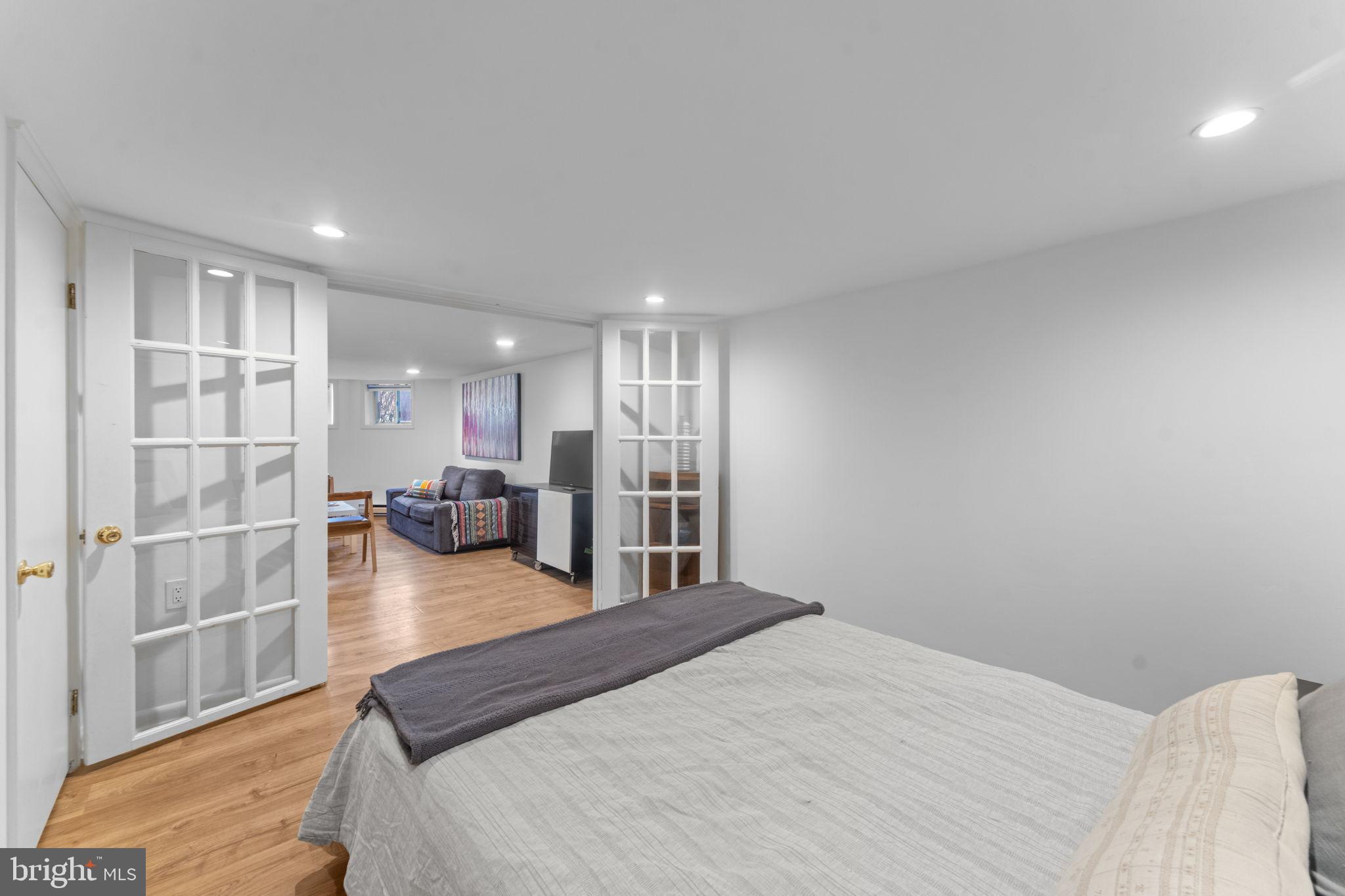 1802 Lamont Street Northwest Washington, DC 20010 - Photo 101 of 118 a spacious bedroom with a bed and a view of kitchen