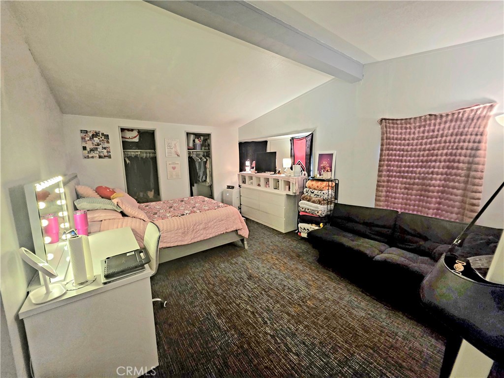 10623 Desert View Road Pinon Hills, CA 92372 - Photo 22 of 76 a bedroom with a bed wooden floor and a couch