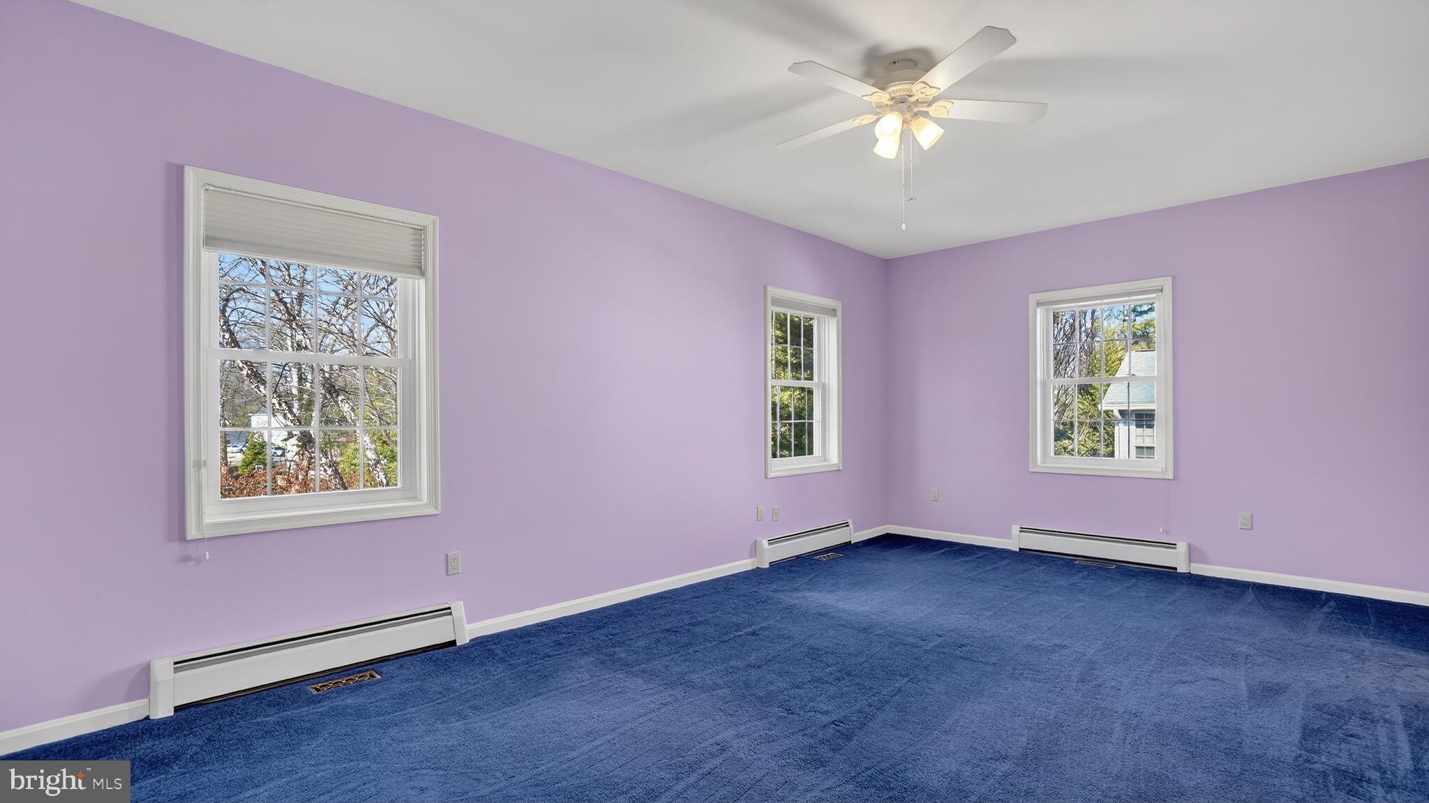 15022 Snowden Drive Silver Spring, MD 20905 - Photo 13 of 88 a view of an empty room with window and a ceiling fan
