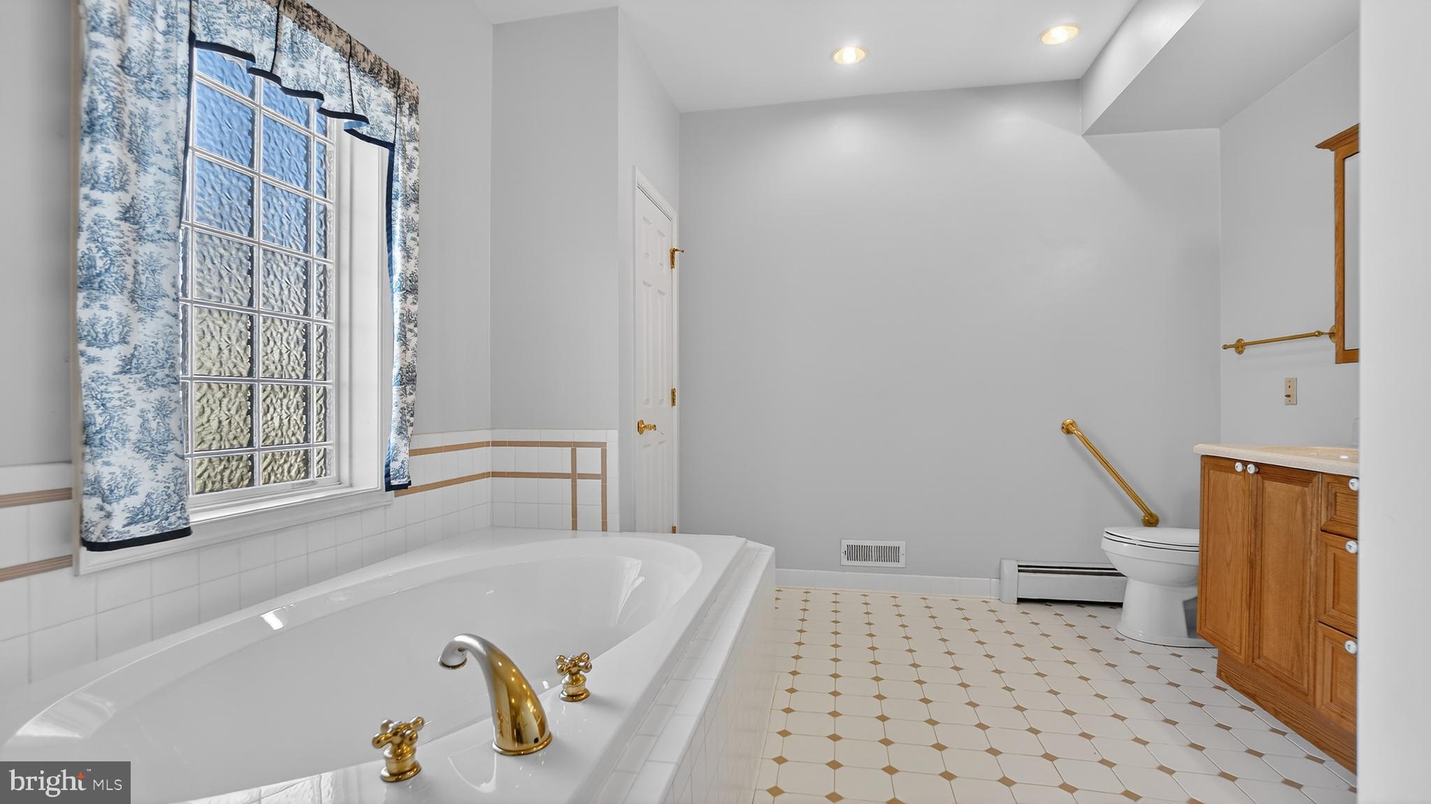 15022 Snowden Drive Silver Spring, MD 20905 - Photo 17 of 88 a bathroom with a bathtub and a shower