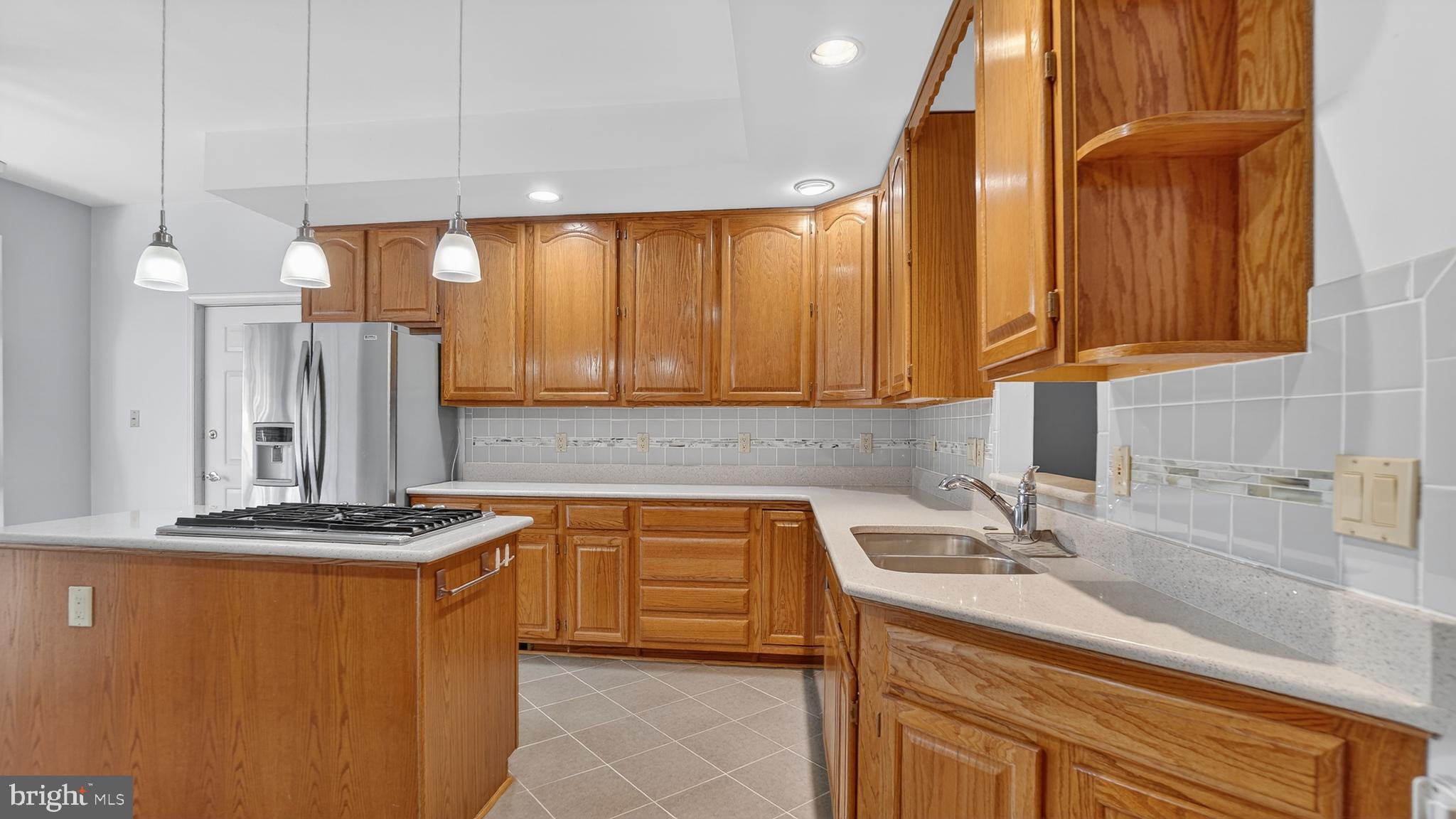 15022 Snowden Drive Silver Spring, MD 20905 - Photo 36 of 88 a kitchen with stainless steel appliances granite countertop a sink a stove and a refrigerator