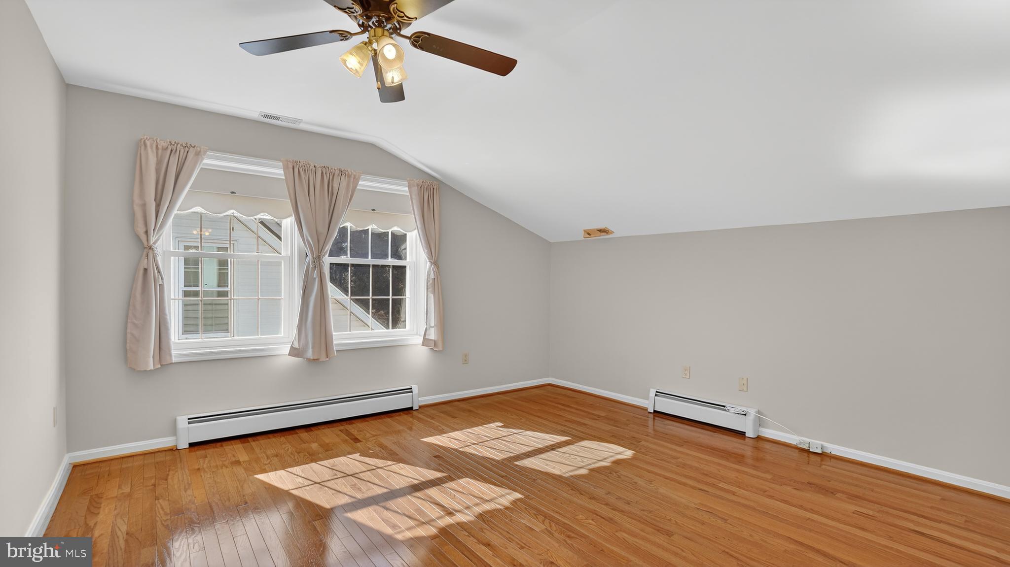 15022 Snowden Drive Silver Spring, MD 20905 - Photo 45 of 88 a view of empty room with wooden floor and fan