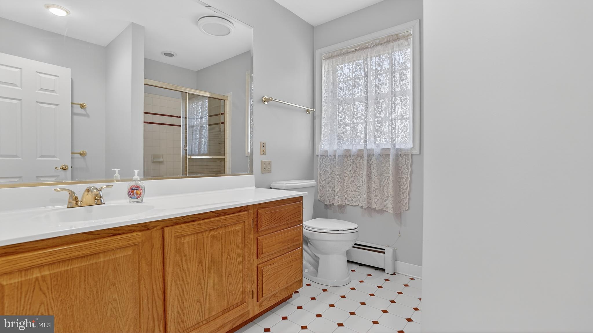15022 Snowden Drive Silver Spring, MD 20905 - Photo 48 of 88 a bathroom with a sink a toilet a shower and a window