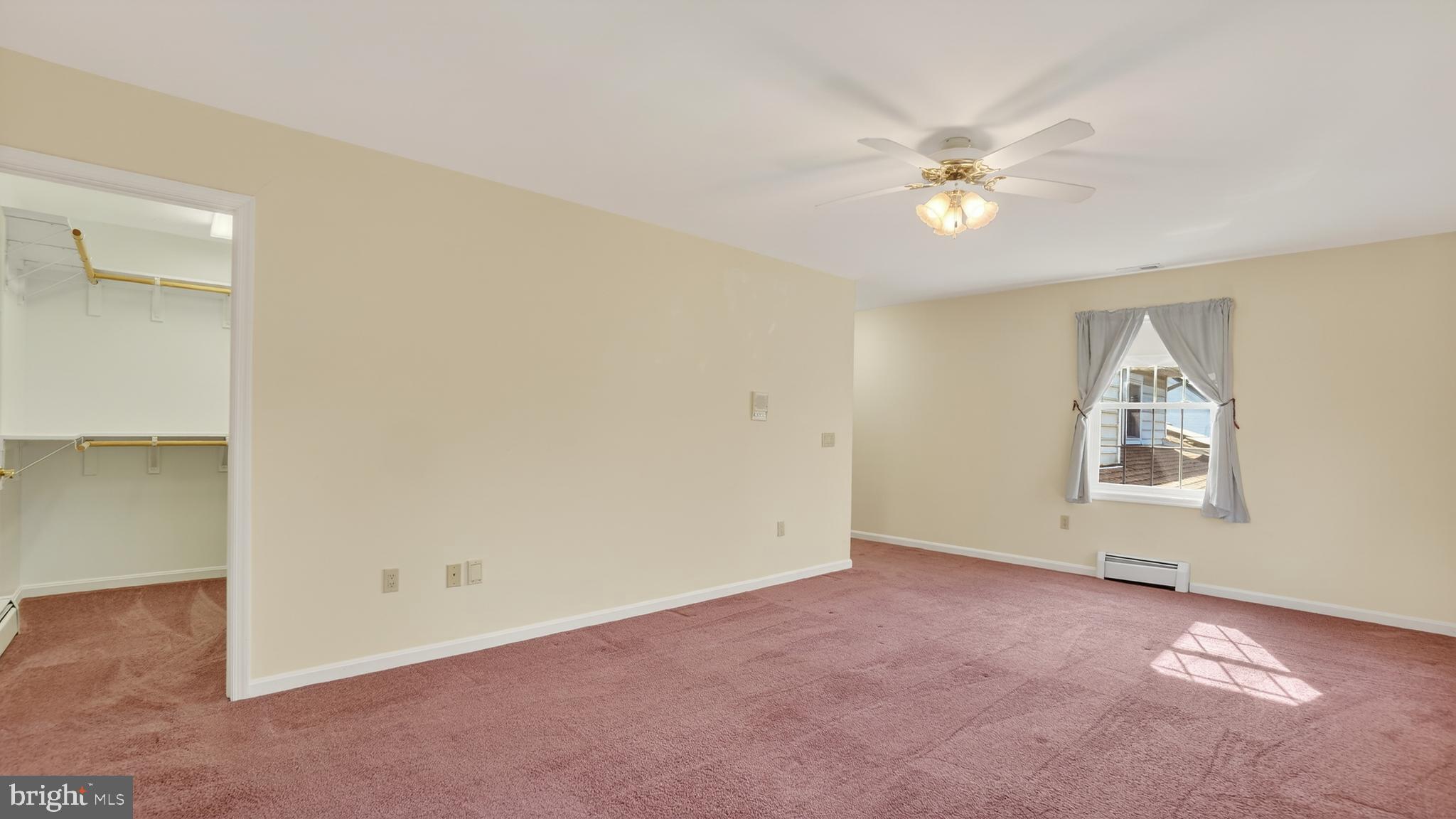 15022 Snowden Drive Silver Spring, MD 20905 - Photo 54 of 88 an empty room with a chandelier fan and windows