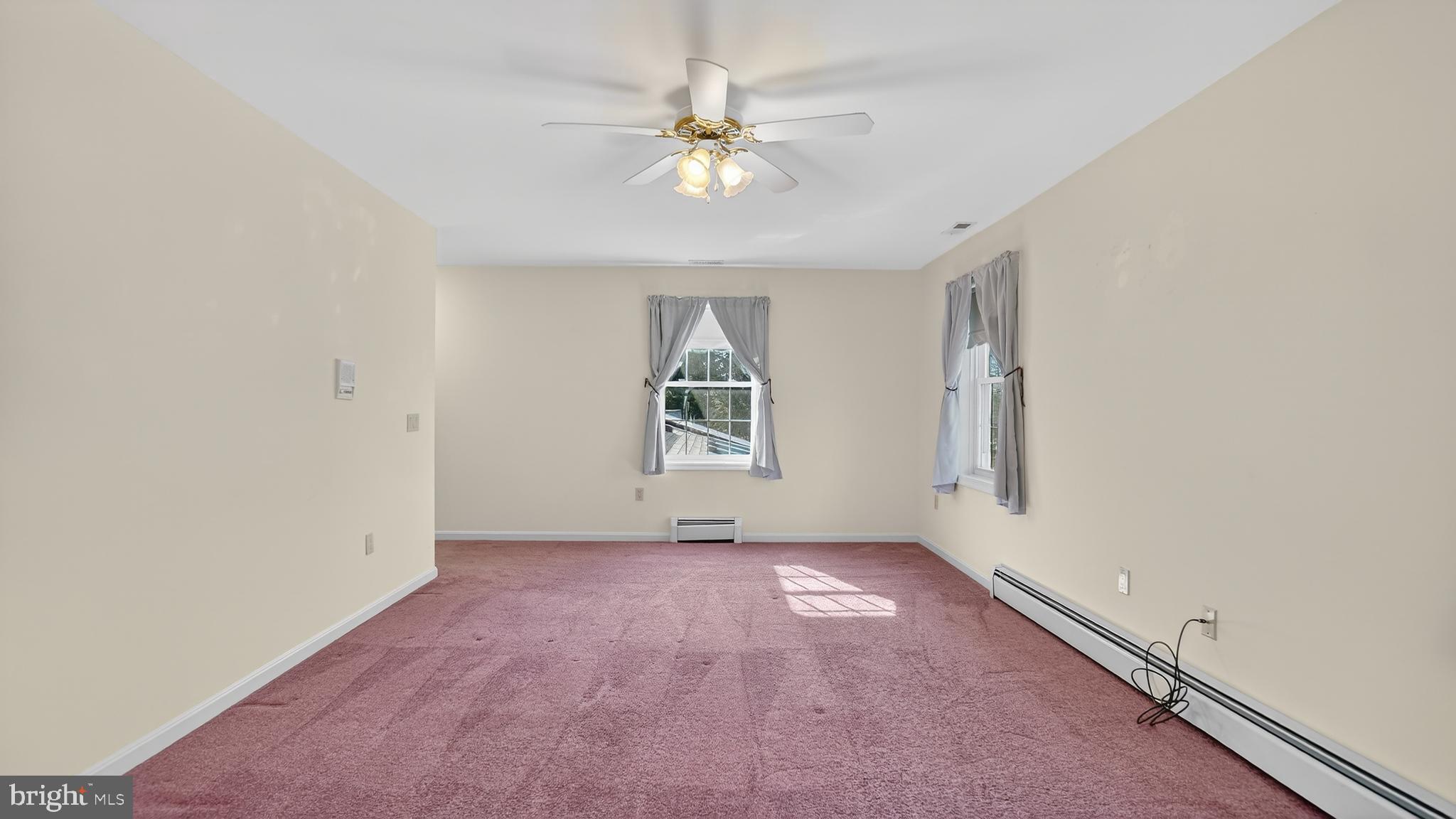 15022 Snowden Drive Silver Spring, MD 20905 - Photo 55 of 88 an empty room with windows and chandelier fan