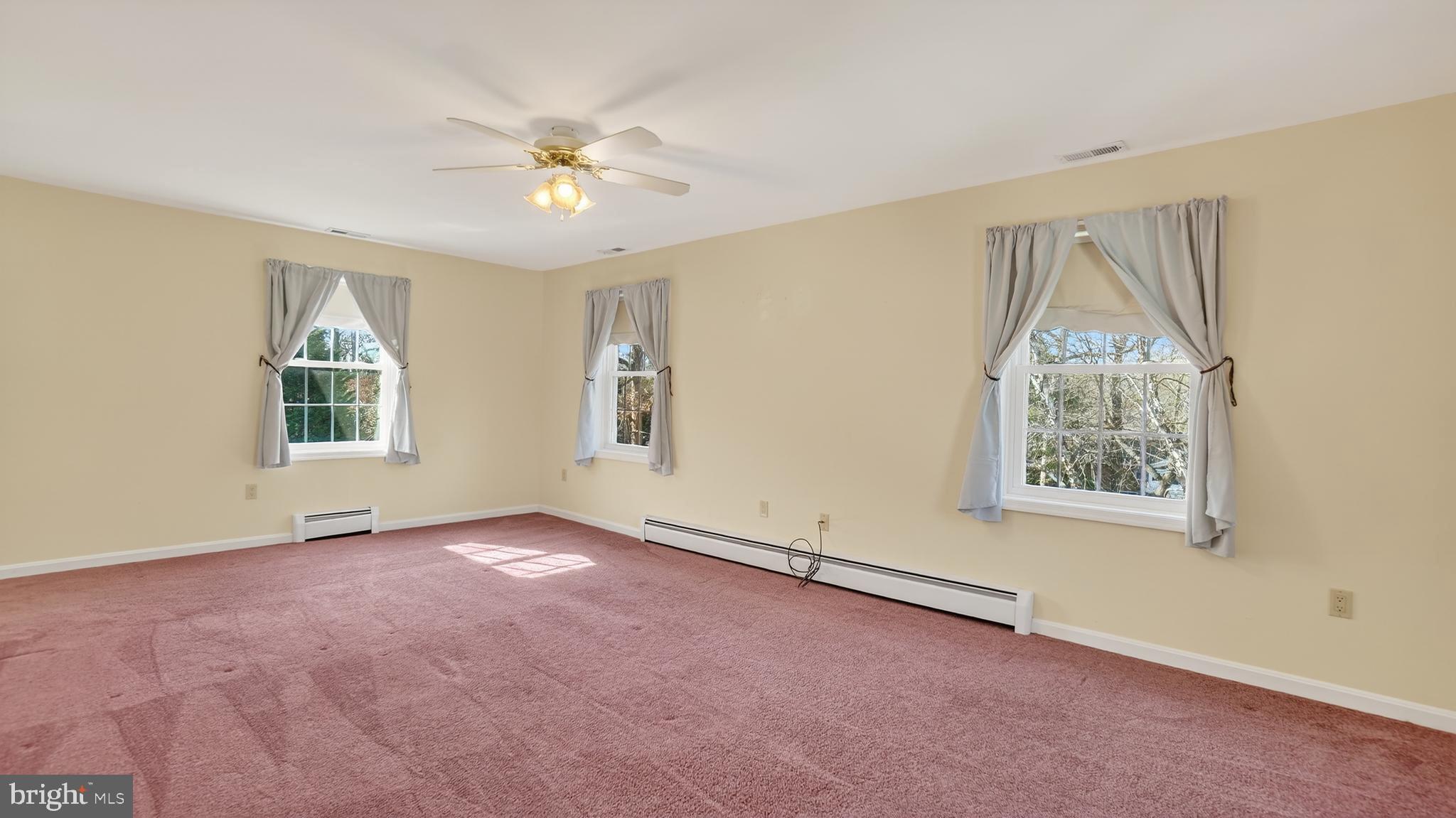 15022 Snowden Drive Silver Spring, MD 20905 - Photo 56 of 88 an empty room with windows and chandelier fan