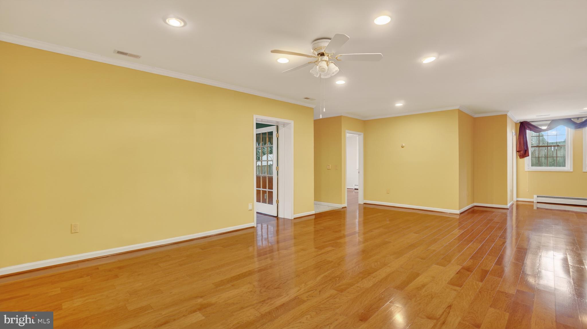 15022 Snowden Drive Silver Spring, MD 20905 - Photo 58 of 88 an empty room with wooden floor and ceiling fan
