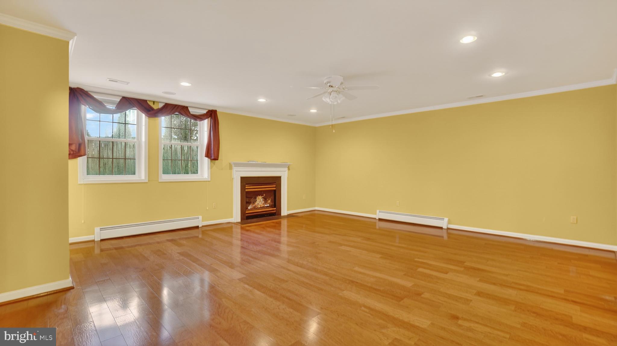 15022 Snowden Drive Silver Spring, MD 20905 - Photo 63 of 88 a view of an empty room with wooden floor and a window