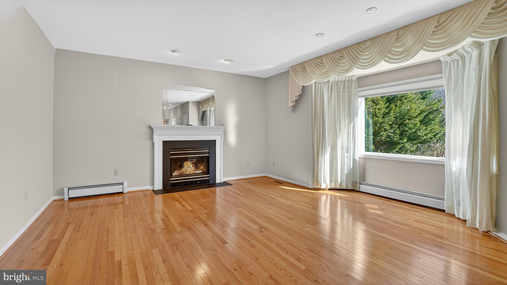15022 Snowden Drive Silver Spring, MD 20905 - Photo 7 of 88 a view of an empty room with a window and fireplace