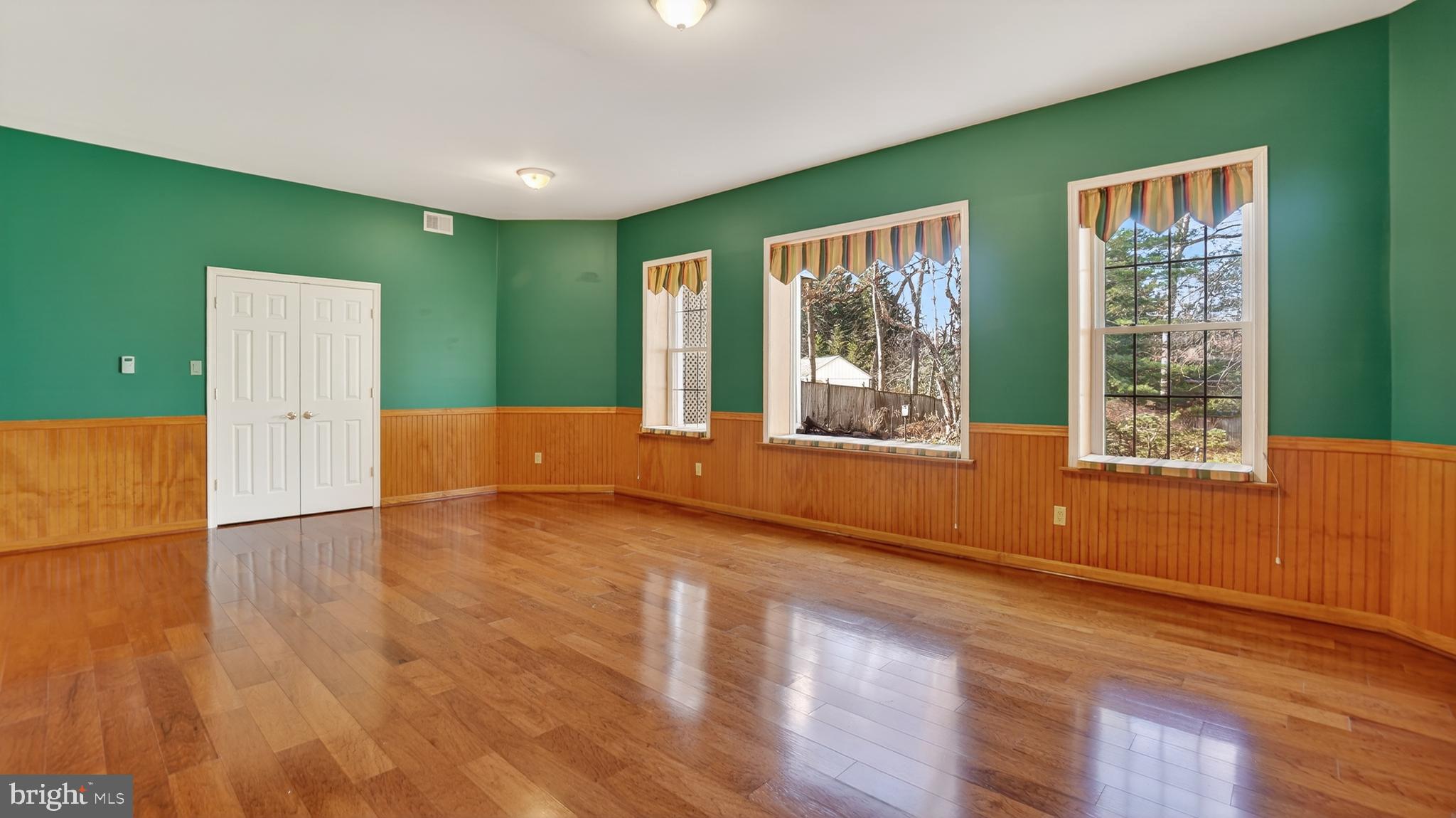 15022 Snowden Drive Silver Spring, MD 20905 - Photo 72 of 88 a view of an empty room with wooden floor and a window