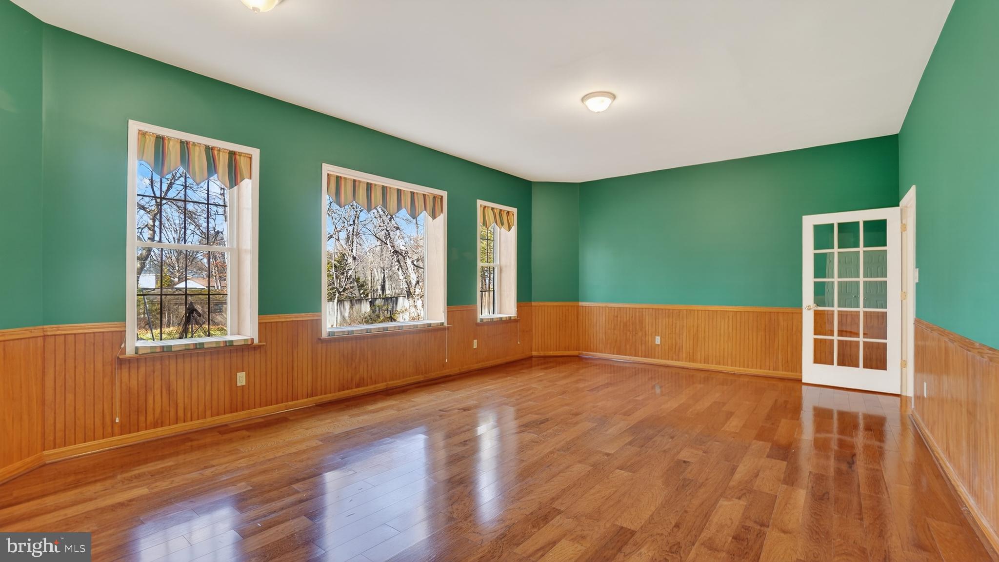 15022 Snowden Drive Silver Spring, MD 20905 - Photo 74 of 88 a view of an empty room with window and wooden floor