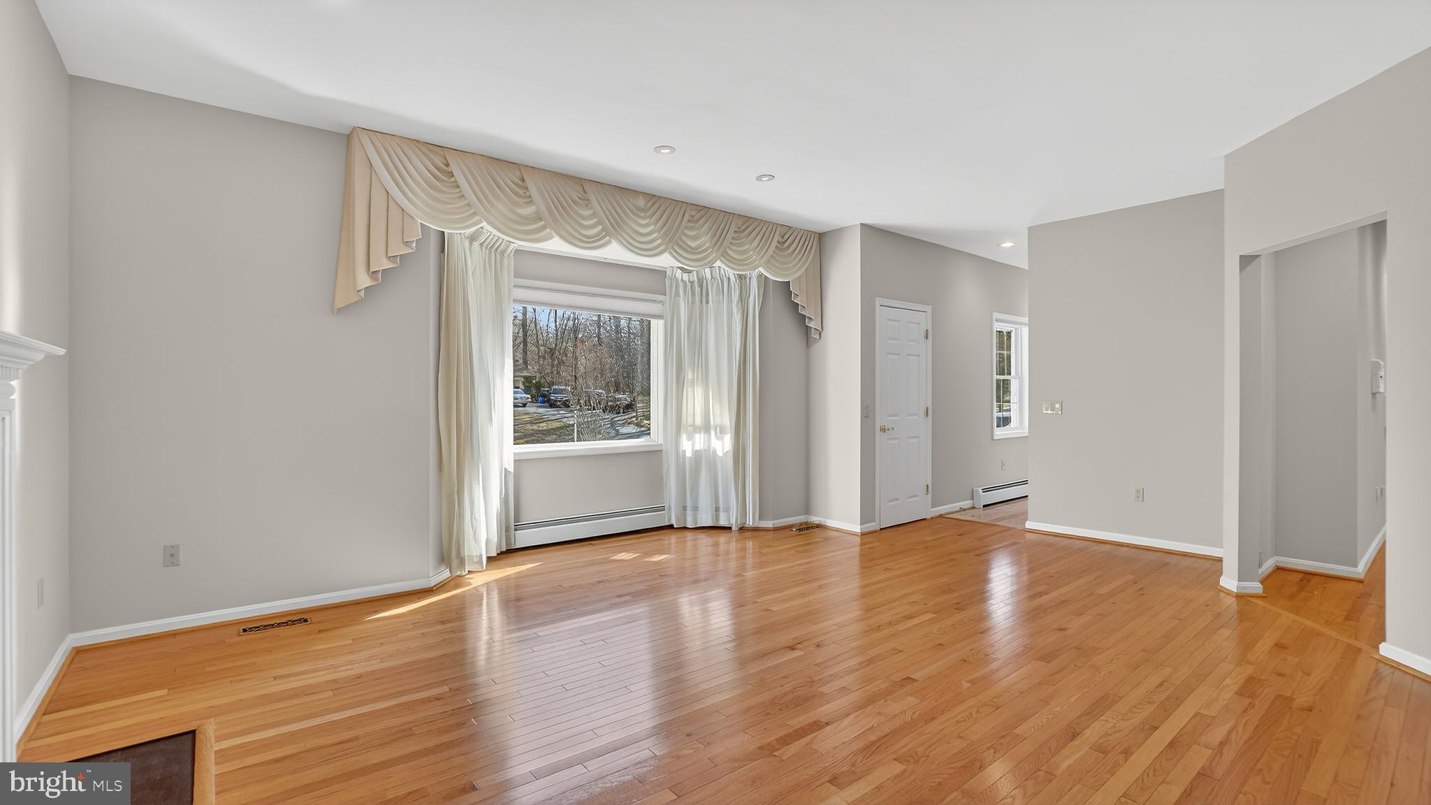 15022 Snowden Drive Silver Spring, MD 20905 - Photo 10 of 88 a view of an empty room with wooden floor and a window