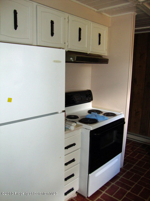 1 Rr Falls Falls, PA 18615 - Photo 4 of 7 a stove top oven sitting inside of a kitchen
