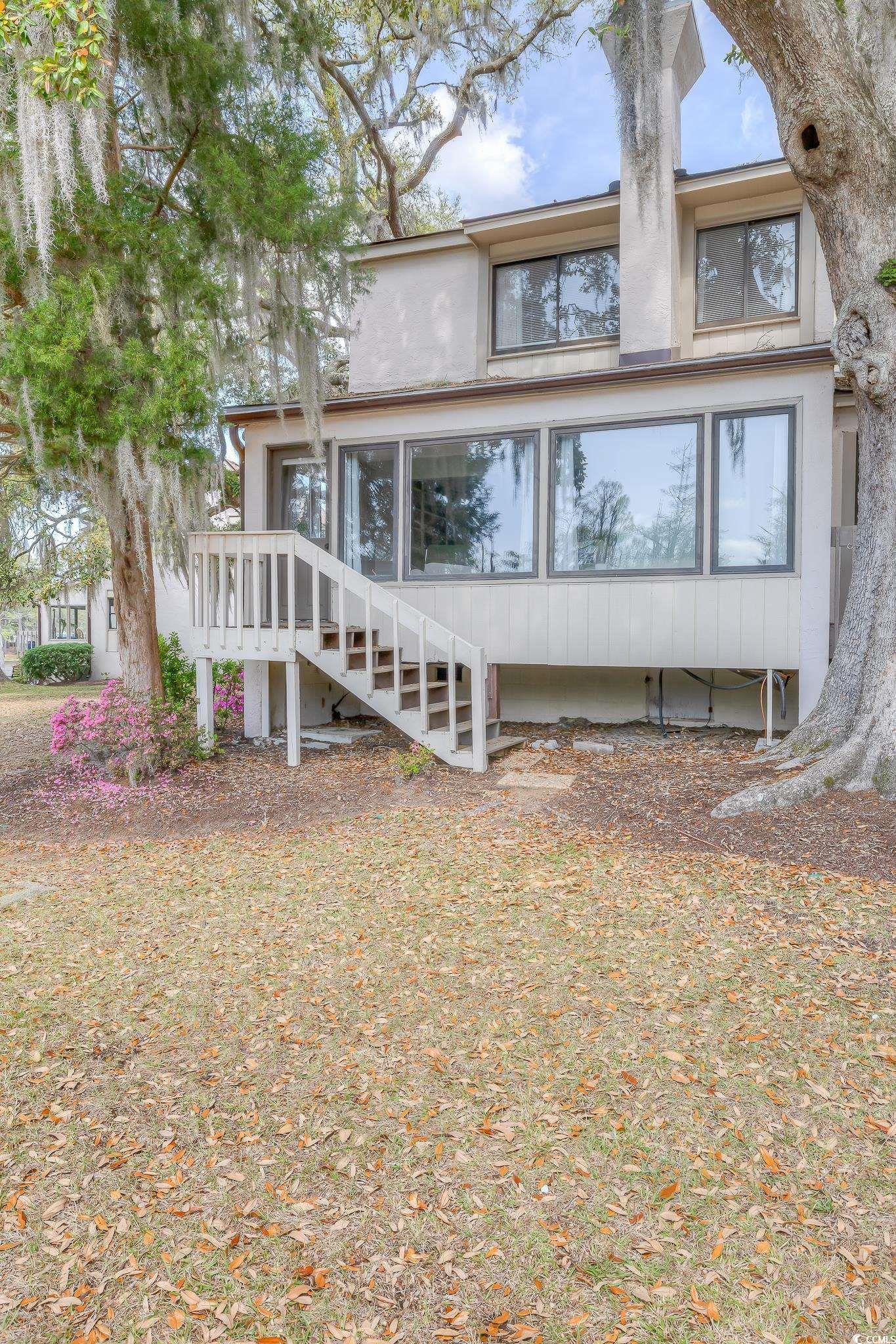 Rear view of house featuring stucco siding