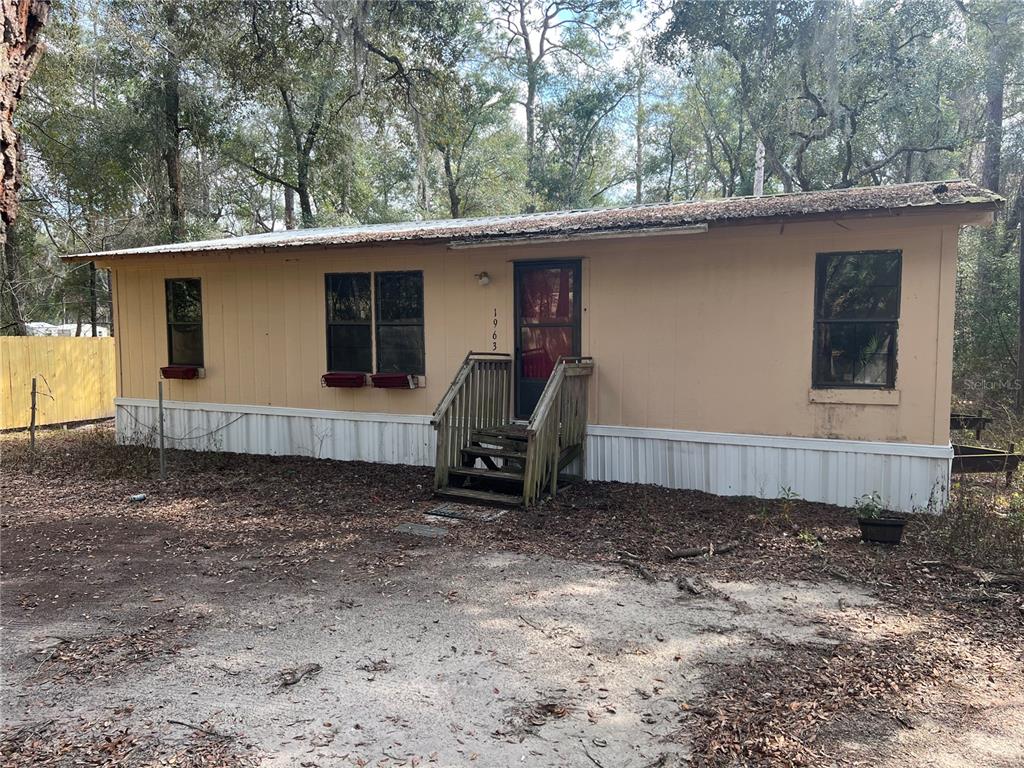 1963 Highway 20 Hawthorne, FL 32640 - Photo 1 of 12 a view of a house with a backyard space and a tree