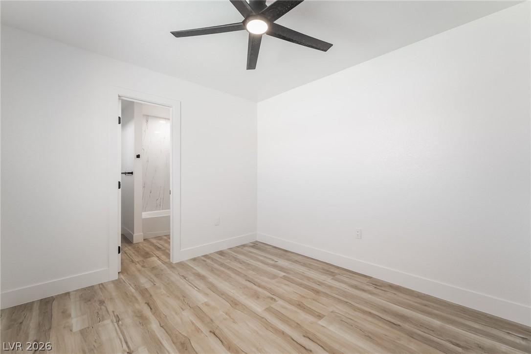 39 Lowery Street Henderson, NV 89015 - Photo 28 of 40 Minimalist interior with a contemporary ceiling fan, perfect for a peaceful retreat.