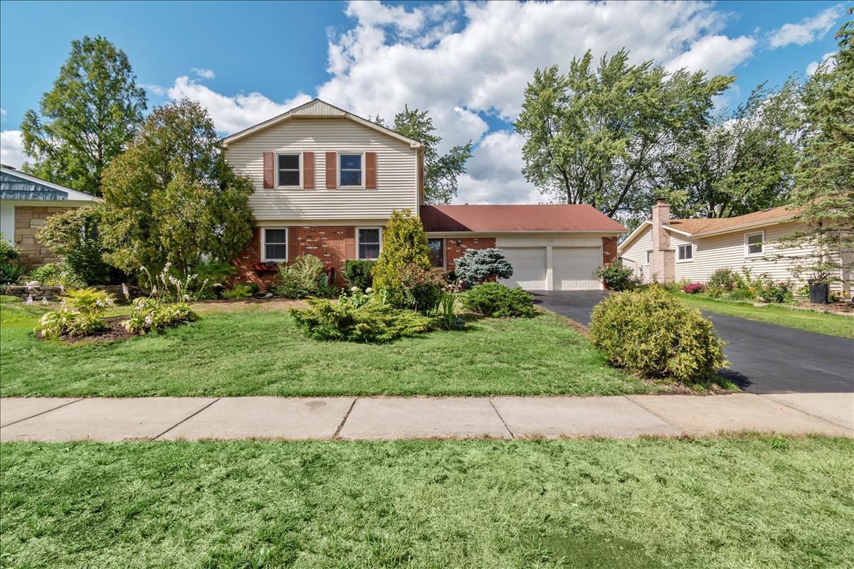 110 Stonegate Road Buffalo Grove, IL 60089 - Photo 1 of 25 a front view of a house with a yard