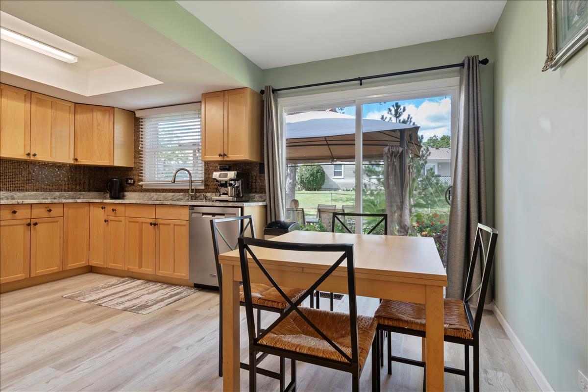 110 Stonegate Road Buffalo Grove, IL 60089 - Photo 11 of 25 a kitchen with a table chairs and wooden floor
