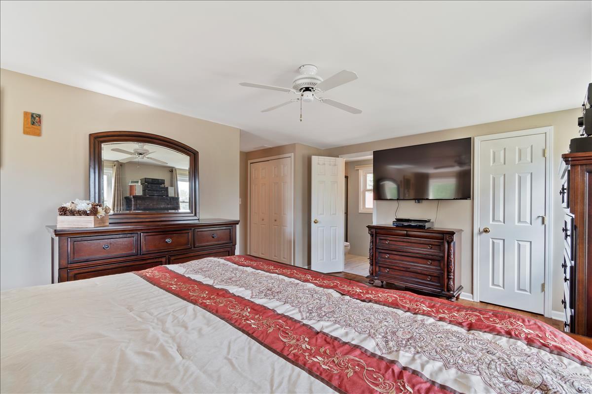 110 Stonegate Road Buffalo Grove, IL 60089 - Photo 15 of 25 a bedroom with a bed and a flat screen tv