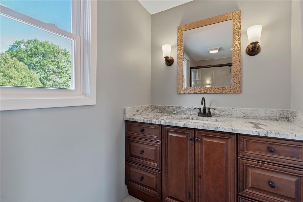 110 Stonegate Road Buffalo Grove, IL 60089 - Photo 16 of 25 a bathroom with a granite countertop sink and a mirror
