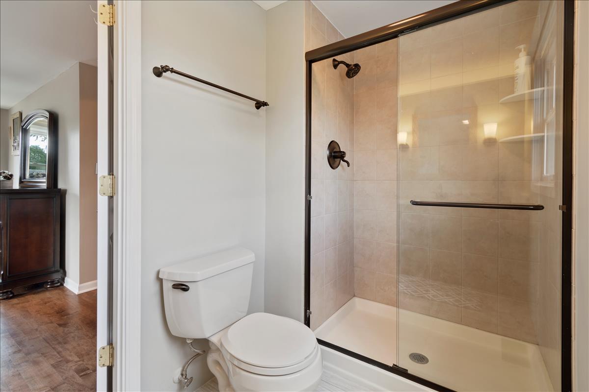 110 Stonegate Road Buffalo Grove, IL 60089 - Photo 17 of 25 a bathroom with a shower and a toilet