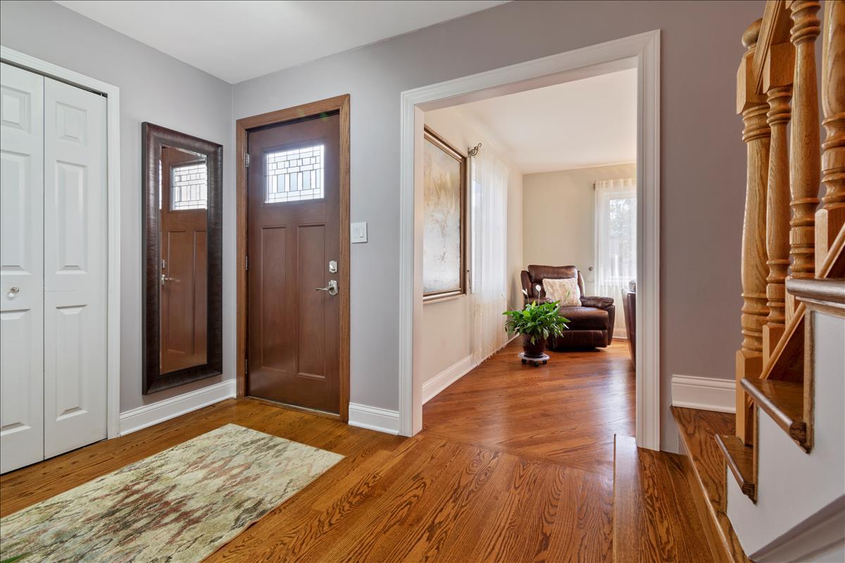 110 Stonegate Road Buffalo Grove, IL 60089 - Photo 3 of 25 a view of a livingroom with wooden floor and a couch