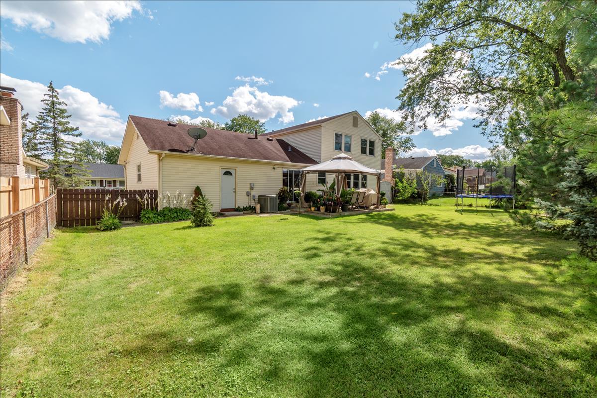 110 Stonegate Road Buffalo Grove, IL 60089 - Photo 23 of 25 a view of a house with a big yard and large trees