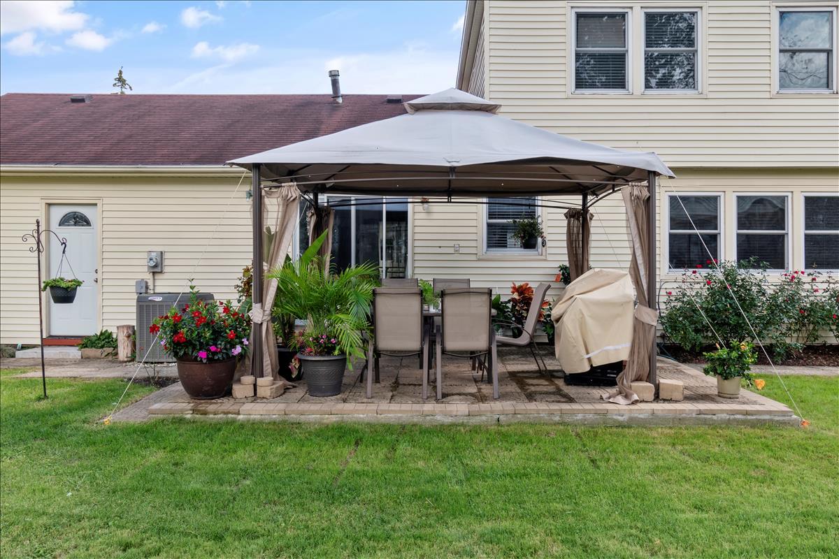 110 Stonegate Road Buffalo Grove, IL 60089 - Photo 25 of 25 a front view of house with a garden and patio