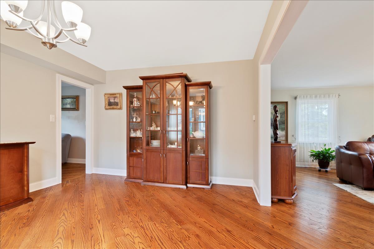 110 Stonegate Road Buffalo Grove, IL 60089 - Photo 6 of 25 a view of an empty room with wooden floor and a window
