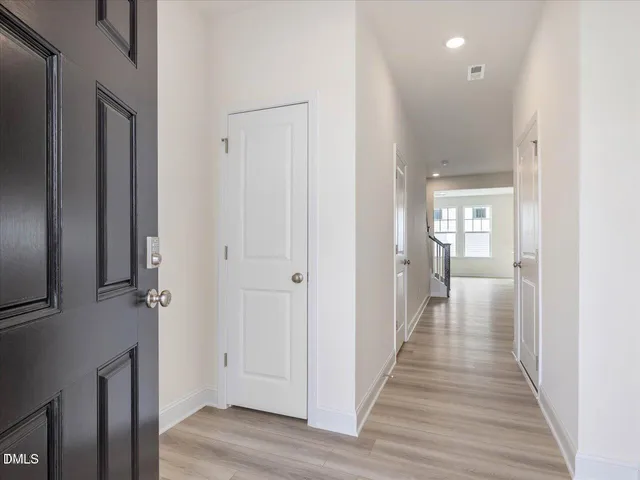 a view of entryway and hall with wooden floor
