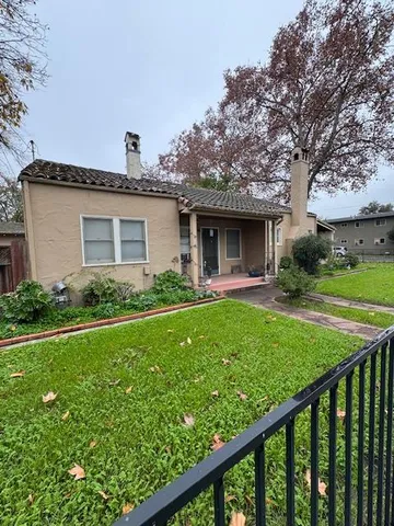 a front view of house with yard and green space